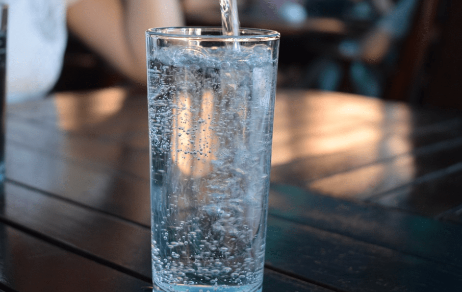 different colored drinks in glasses