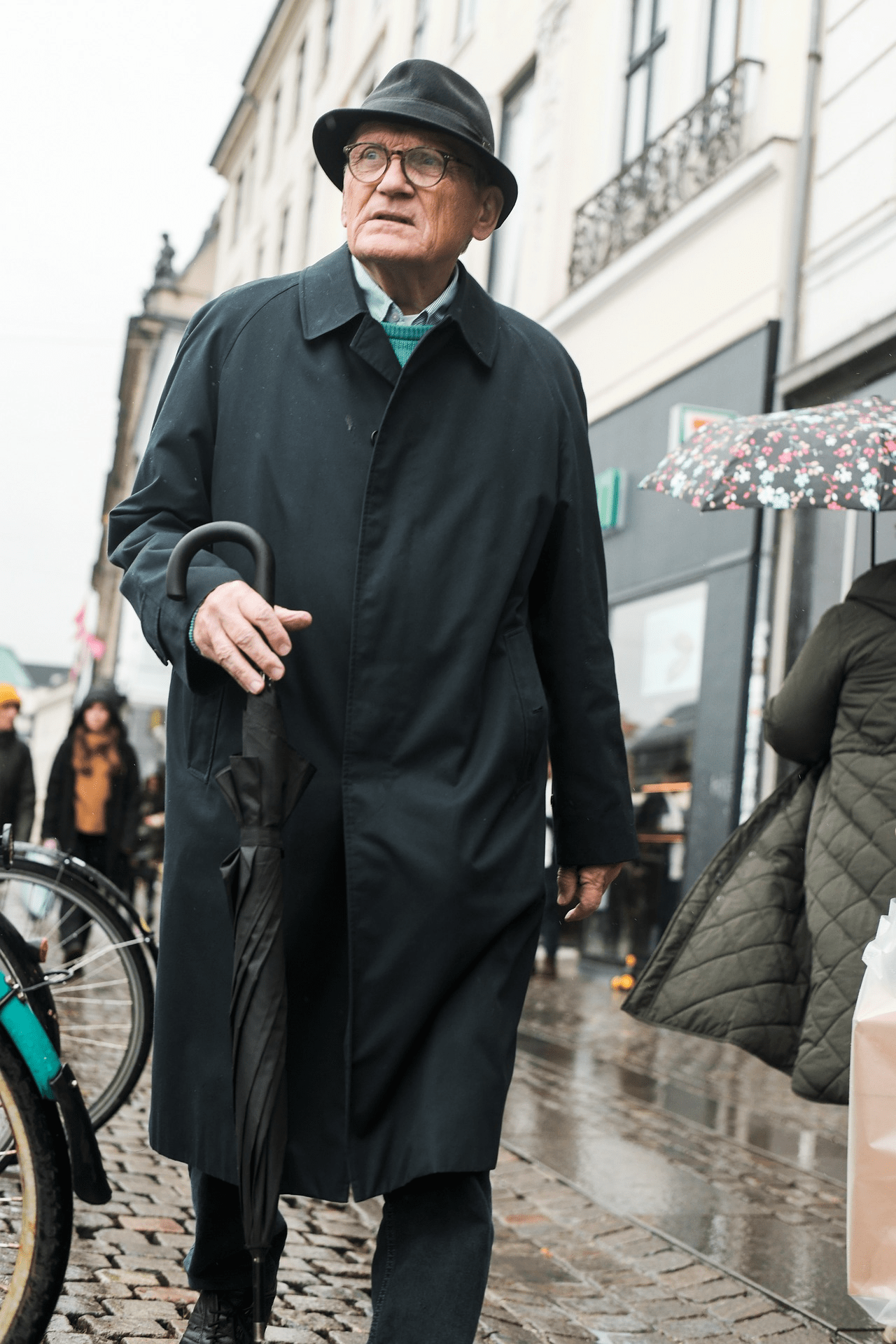Man in black coat and umbrella