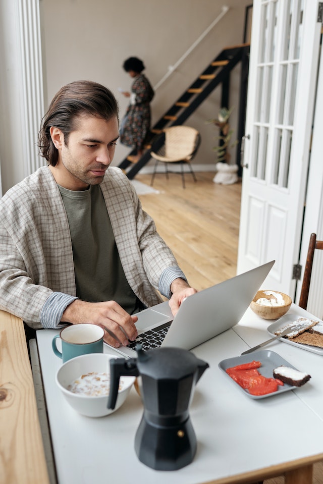 man wearing blazer having breakfast