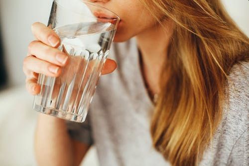A girl drinking a glass of water