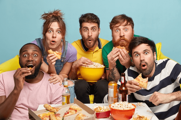 A group of people eating heavy food