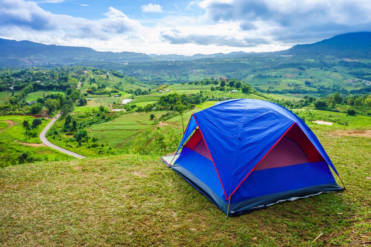 blue tent on a green hill