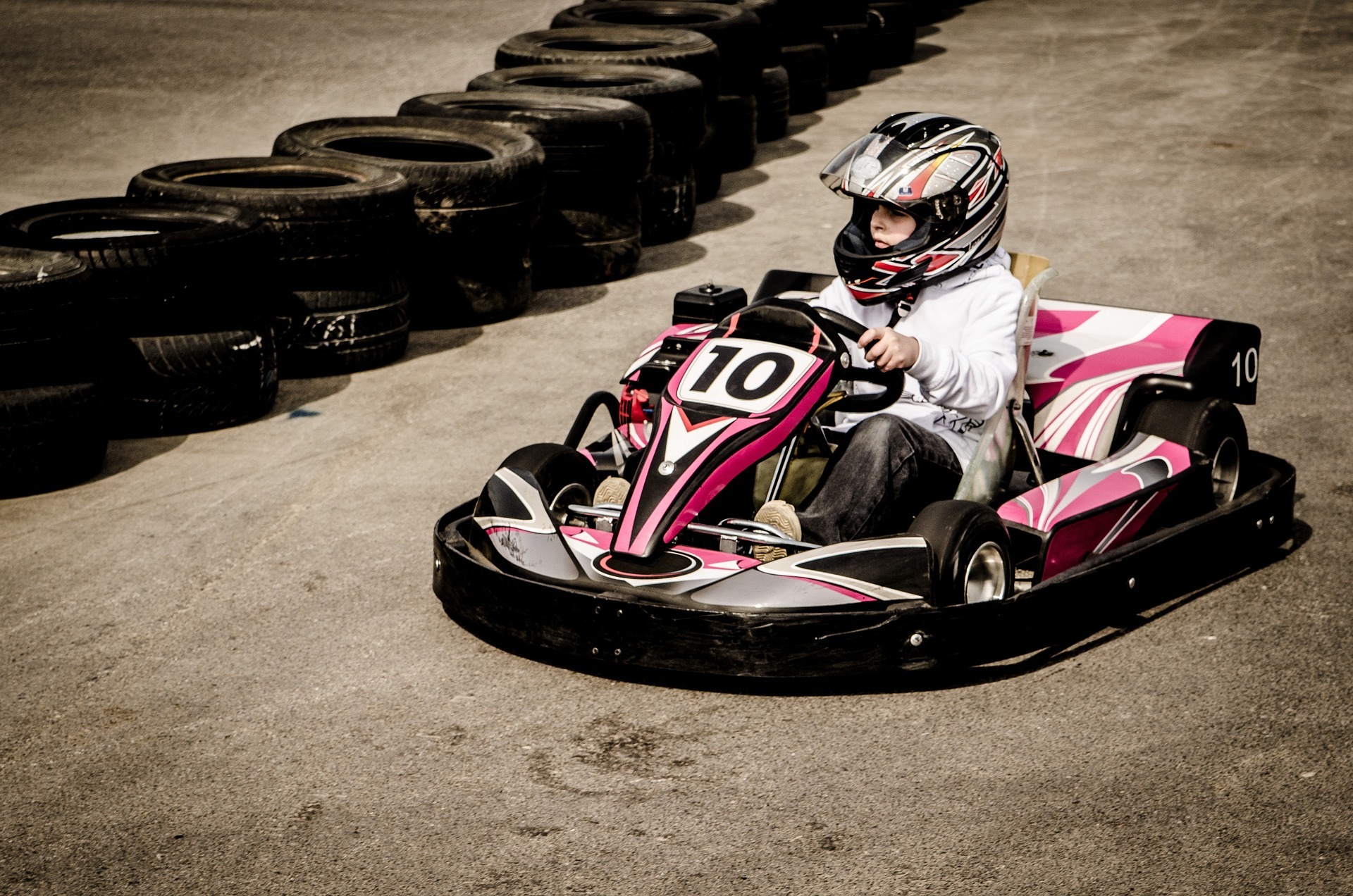 child in pink go-kart