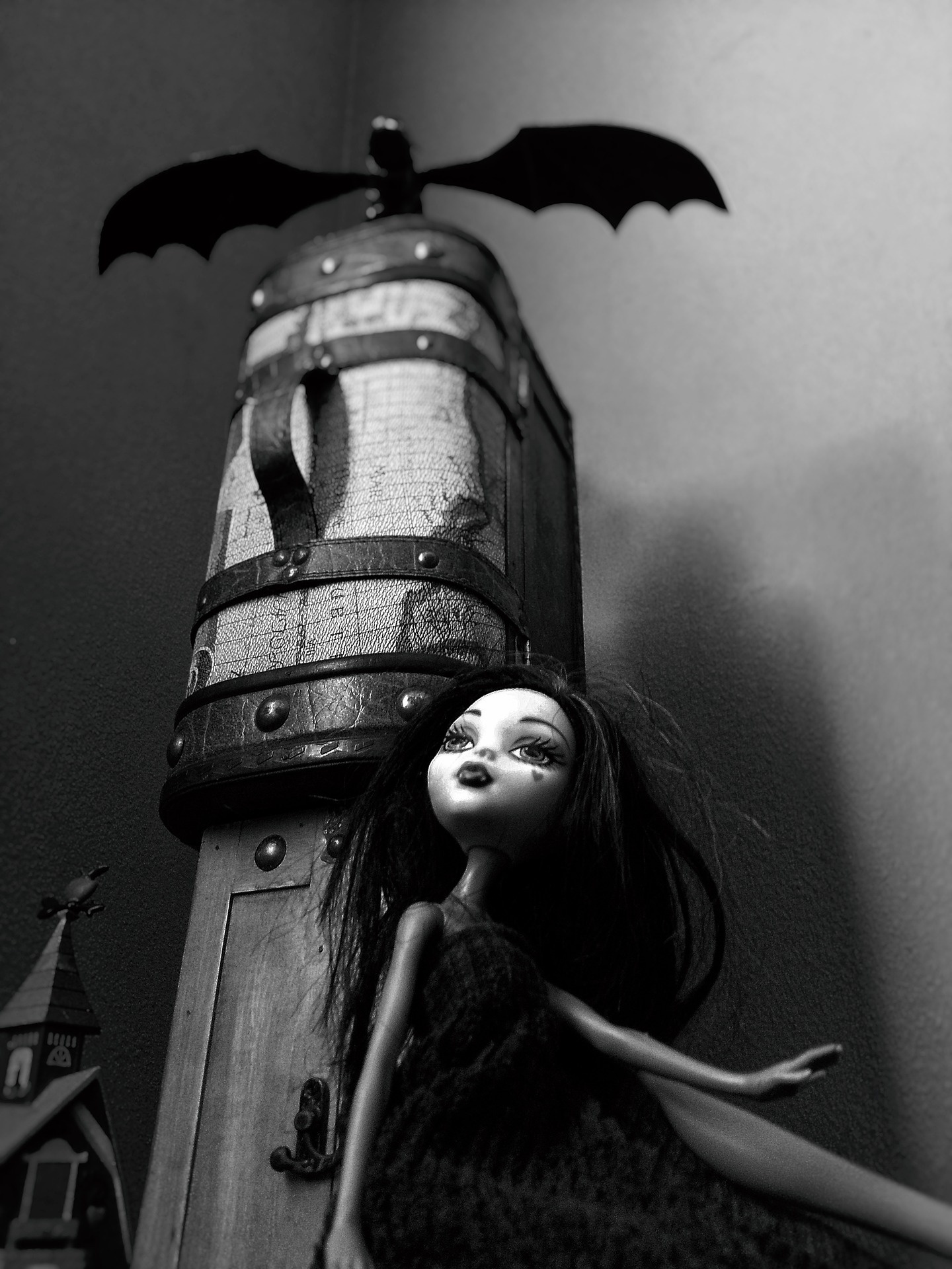 Monster High doll sitting in black and white