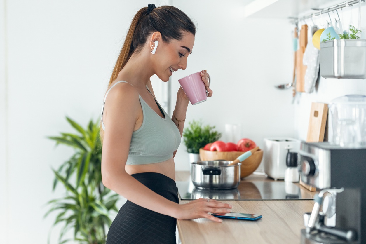 a fit and healthy woman drinking a cup of coffee